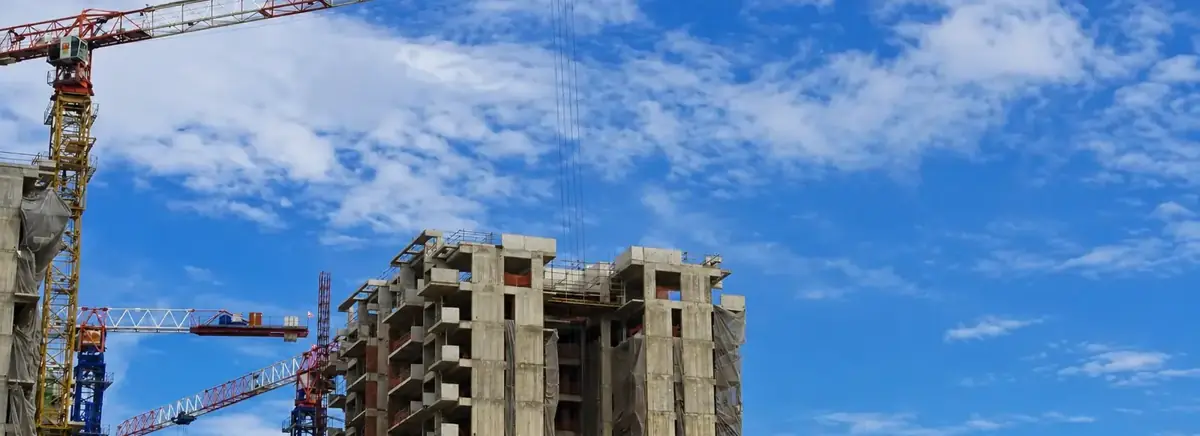 Multi-storey building under construction with tower cranes